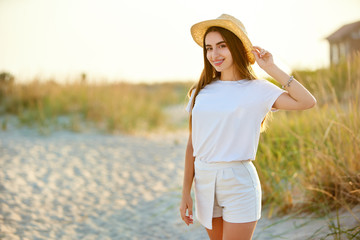 Spa wellness beach beauty woman relaxing and sun bathing on beach. Beautiful serene and peaceful...