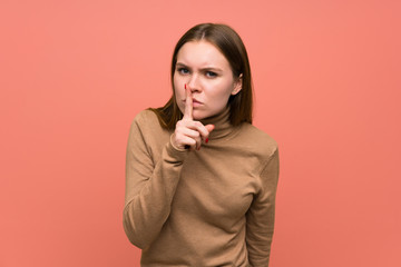 Young woman over colorful background doing silence gesture
