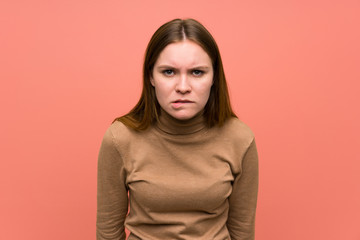 Obraz premium Young woman over colorful background having doubts and with confuse face expression