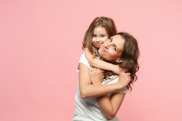 Woman in light clothes have fun with cute child baby girl. Mother, little kid daughter isolated on...