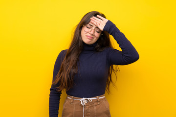 Teenager girl over isolated yellow wall with tired and sick expression