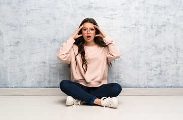 Teenager student girl studying in a table with surprise expression