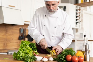 Chef cutting fresh and delicious vegetables for cooking.