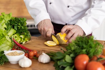 Chef cutting fresh and delicious vegetables for cooking.