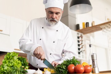 Chef cutting fresh and delicious vegetables for cooking.