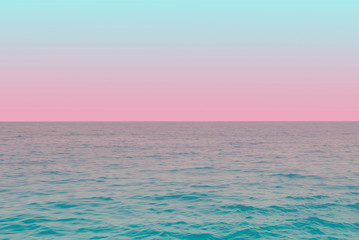 Fototapeta na wymiar tender view of green water and blue pink gradient sky