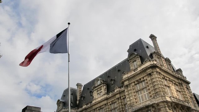 Flag of France waving in the wind against the blue sky. The concept of patriotism. Slow Motion.