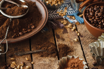 Roasted black and green coffee beans and ground coffee in the plate