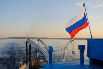 ship board on a river view background. russian flag