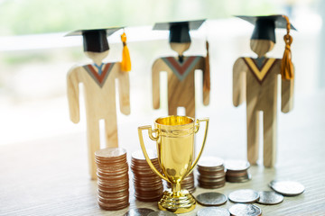 Education graduation in achievement success concept: golden trophy winner with rising money coins with Students university models, management study competition leadership and inspiration in life