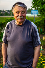 Mustachioed old man resting in the Park