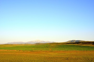 Fototapeta na wymiar Rural area dawn landscape of fields and mountains near Saryozek, Almaty region