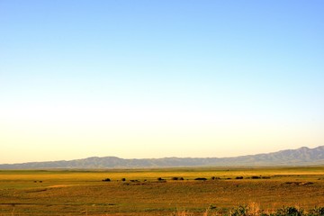 Rural area dawn landscape of fields and mountains near Saryozek, Almaty region