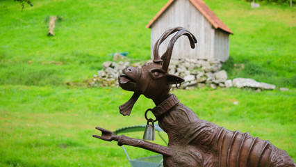 metal goat statue pointing left