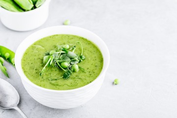 Summer cream soup with green fresh pea shoots