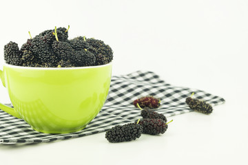 mulberry fruit on green mug