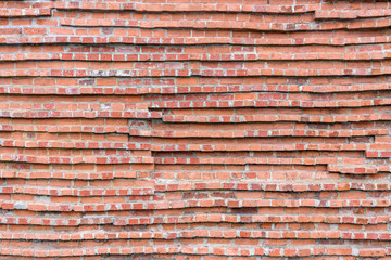 red brick wall of a very unusual texture with horizontal veins