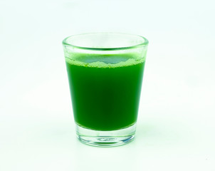 shot of wheat grass juice on white background