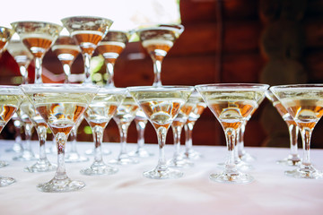 The waiter pours champagne to a party. glasses of champagne.