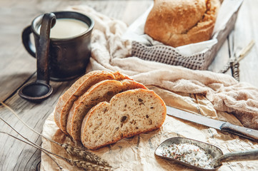 A beautiful loaf of sourdough bread from white wheat on a plate on a linen edge. Homemade pastries