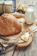 A beautiful loaf of sourdough bread from white wheat on a plate on a linen edge. Homemade pastries