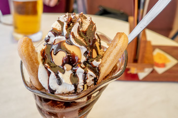 Ice cream. Dessert based on vanilla ice cream and chocolate syrup with cookies. cup with ice cream