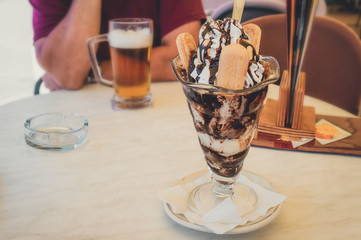 Ice cream. Dessert based on vanilla ice cream and chocolate syrup with cookies. cup with ice cream