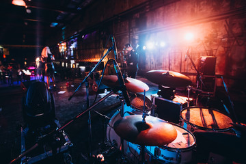 drum set at a party. musical instrument. club hall illuminated by spotlights. - obrazy, fototapety, plakaty