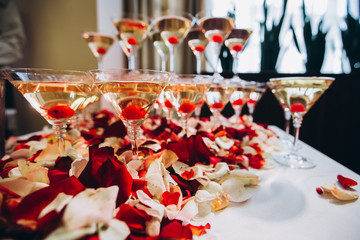 The waiter pours champagne to a party. glasses of champagne.