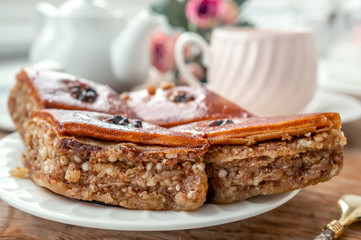 Traditional arabic dessert baklava with a cup of coffee, cashews, walnuts and cardamom on a wooden table. Homemade Baklava with Nuts and Honey
