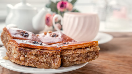 Traditional arabic dessert baklava with a cup of coffee, cashews, walnuts and cardamom on a wooden table. Homemade Baklava with Nuts and Honey