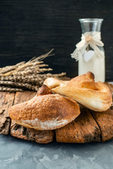 Russian national bread Kalach on a wooden background. National bread products