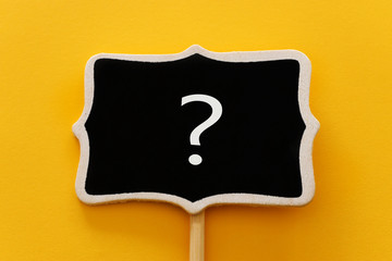 Chalkboard with question mark sign over yellow background