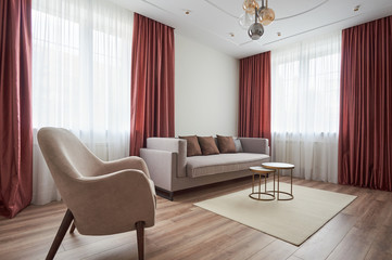 small living room with a sofa, armchair, coffee table and carpet