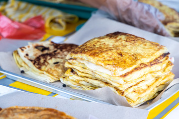 Seller preparing murtabak at street stall for iftar during Ramadan.