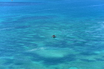 Naklejka premium Passanger ship sailing in crystal blue water near to Bukit Merese Hills near Lombok Island, Indonesia