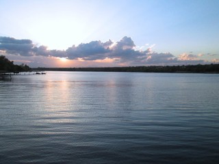 Sunset stormy sky reflected in the water of the river