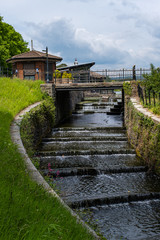 Fototapeta premium Roath Park Waterfall Cardiff on a Summer Sunny Cloudy Day