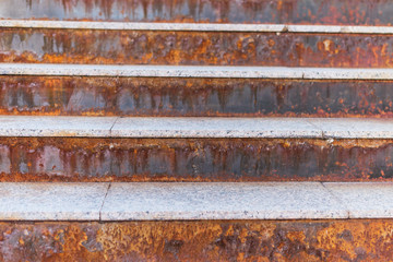 rusty staircase with streaks. Orange staircase.