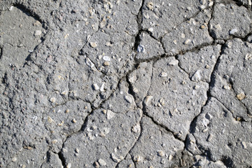 Macro closeup on concrete asphalt cracks on the road