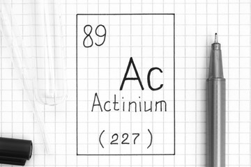 Handwriting chemical element Actinium Ac with black pen, test tube and pipette.