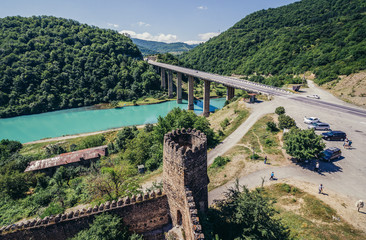 View of bridge over Arakala river. Walls of Ananuri Castle on foreground, Georgia
