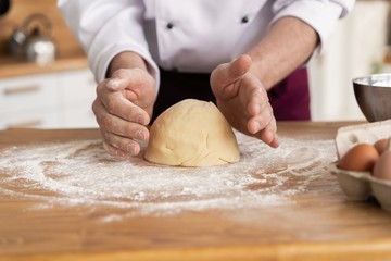 Wheat bread to the oven. The Baker's hands. Process the dough for wheat bread.