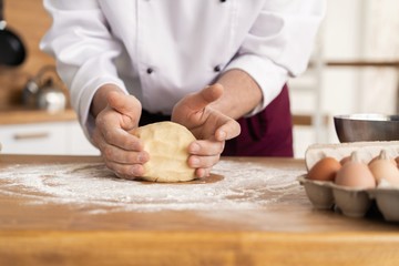 Wheat bread to the oven. The Baker's hands. Process the dough for wheat bread.
