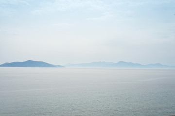 Beautiful mysterious nature background with of the ocean against the misty mountains