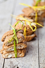 Fresh homemade Italian cookies cantuccini with almond seeds on ructic wooden table background.