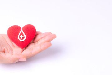 Woman hands holding red heart for blood donation,world blood donor day. Copy space for advertisers.