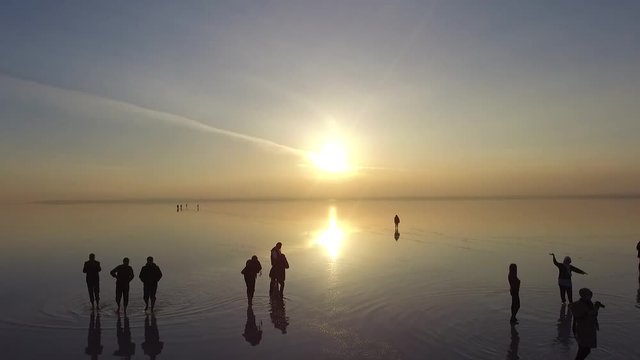 silhouette of people at sunset drone fly