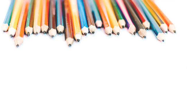 colored pencils on white table, back to school education concept background.
