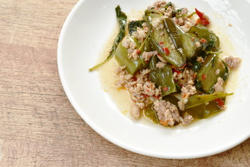 spicy stir fried slice eggplant with minced pork and basil leaf on plate